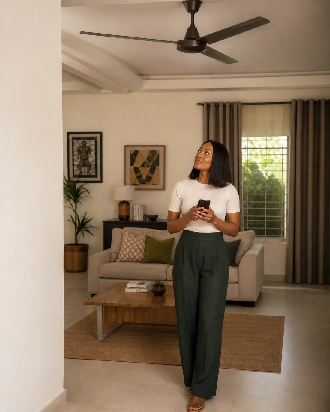 A requester using her phone to arrange help for a faulty ceiling fan